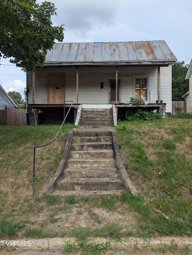 view of front of house with covered porch and a front yard