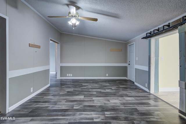 unfurnished room featuring a ceiling fan, wood finished floors, a textured ceiling, crown molding, and a decorative wall