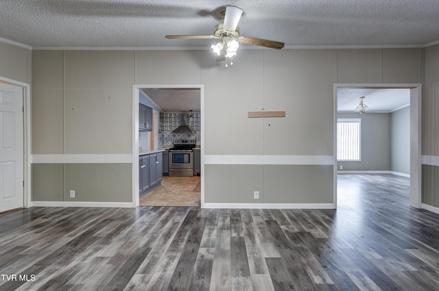 unfurnished living room with ceiling fan, wood finished floors, a textured ceiling, and ornamental molding