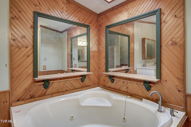 bathroom featuring a tub with jets and wood walls