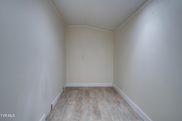 additional living space with vaulted ceiling, baseboards, and light wood finished floors