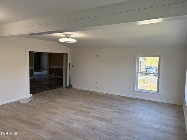 empty room with baseboards and wood finished floors