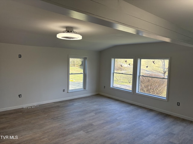 empty room featuring dark wood-type flooring and baseboards