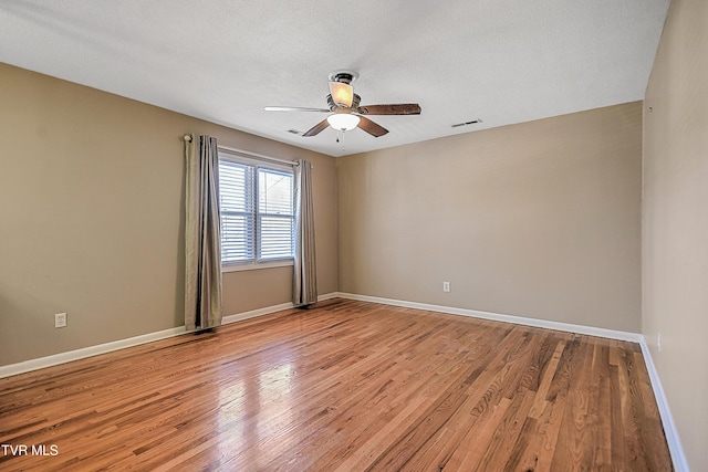 spare room featuring ceiling fan and light hardwood / wood-style flooring