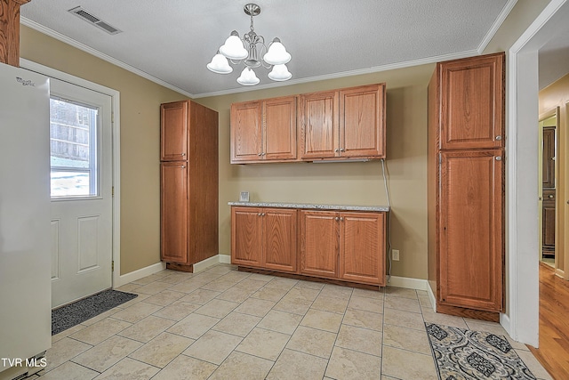 kitchen with an inviting chandelier, a textured ceiling, refrigerator, ornamental molding, and hanging light fixtures