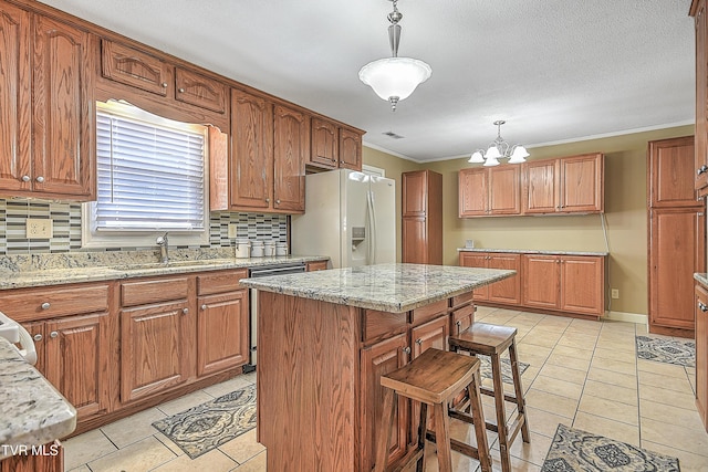 kitchen featuring white fridge with ice dispenser, dishwasher, a center island, pendant lighting, and tasteful backsplash