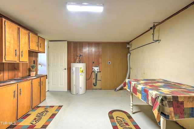 garage with water heater and wooden walls