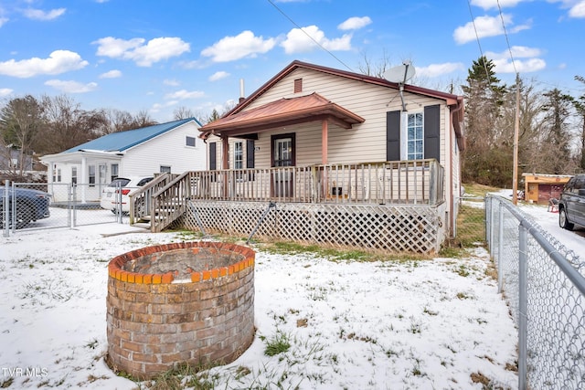 bungalow with a fire pit and covered porch