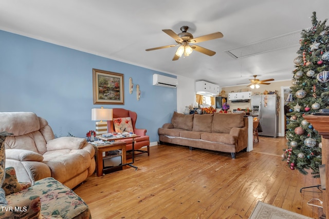 living room featuring a wall unit AC, ceiling fan, light hardwood / wood-style floors, and ornamental molding