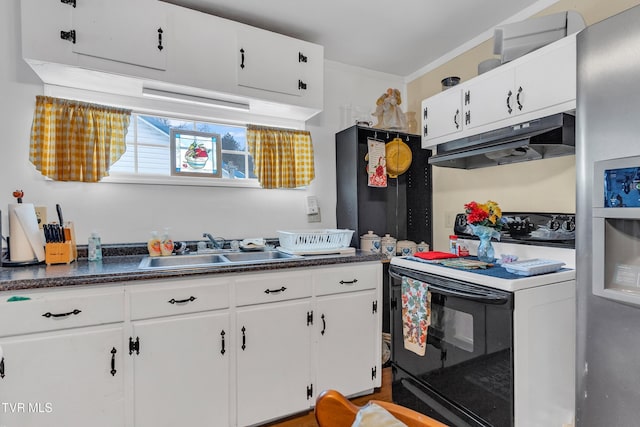 kitchen featuring sink, stainless steel fridge, range with electric cooktop, and white cabinetry