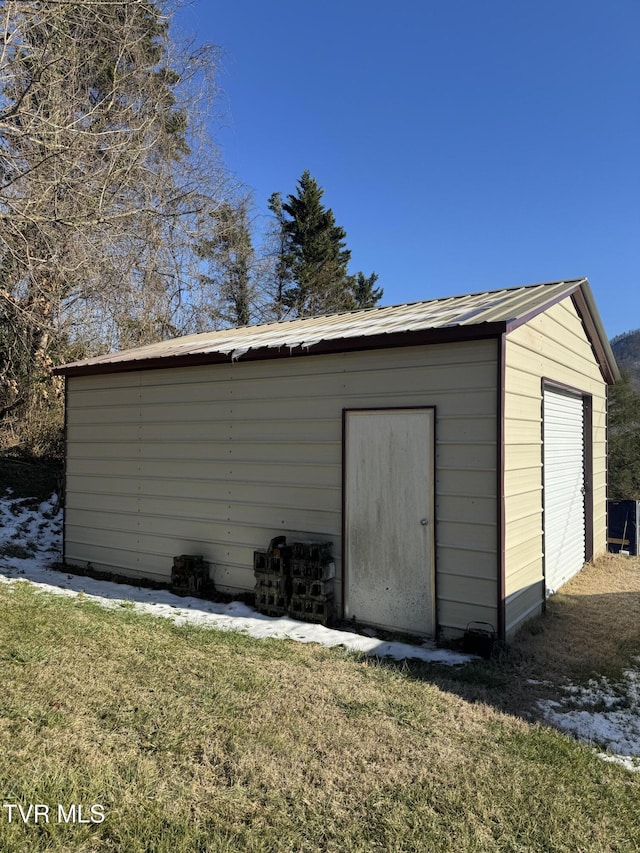 view of outbuilding with a yard and a garage