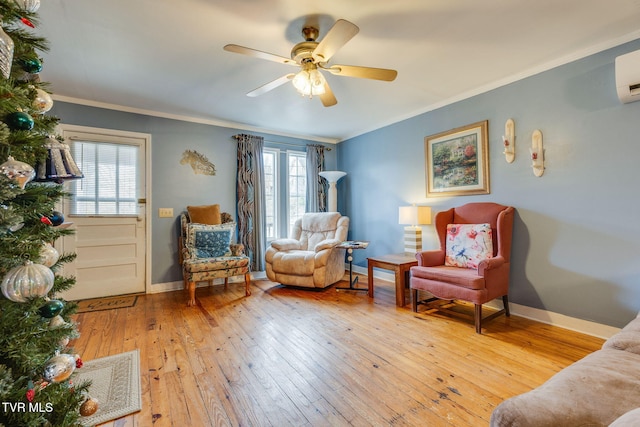 living area with wood-type flooring, baseboards, ceiling fan, and crown molding