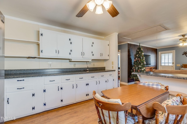 kitchen featuring ornamental molding, light wood-type flooring, white cabinetry, and open shelves