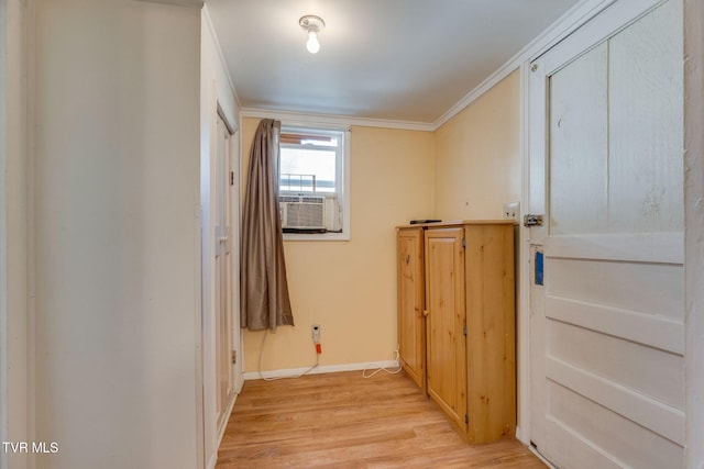 interior space featuring light wood finished floors, ornamental molding, cooling unit, and baseboards