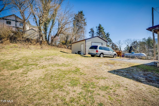 view of yard with a garage and an outdoor structure