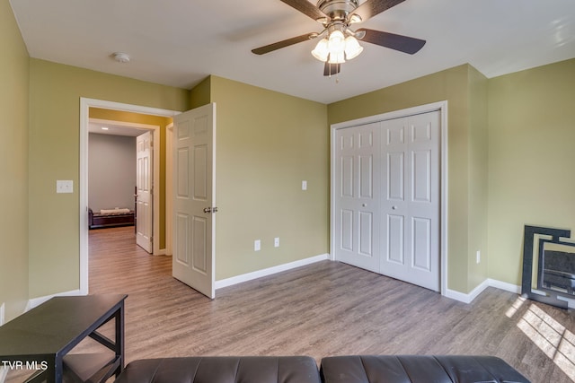 interior space with ceiling fan and light hardwood / wood-style flooring