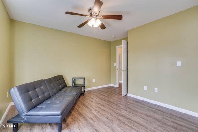 sitting room with light hardwood / wood-style floors and ceiling fan