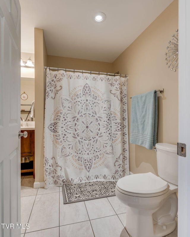 bathroom featuring tile patterned floors, vanity, and toilet