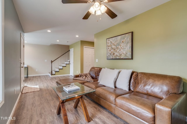 living room with ceiling fan and light wood-type flooring