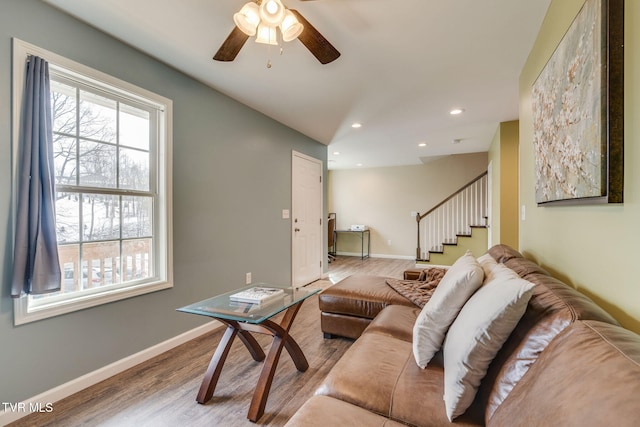 living room featuring ceiling fan and hardwood / wood-style flooring