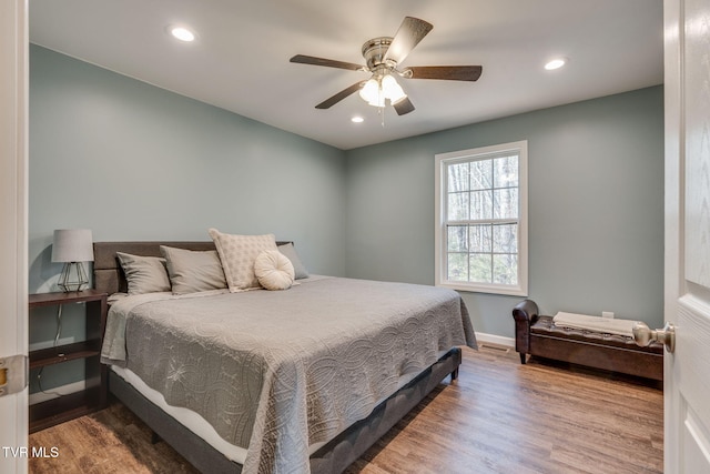 bedroom featuring ceiling fan and hardwood / wood-style flooring