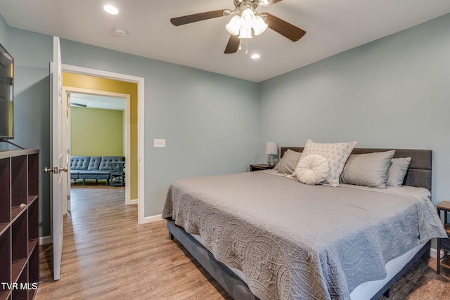 bedroom featuring ceiling fan and light hardwood / wood-style flooring