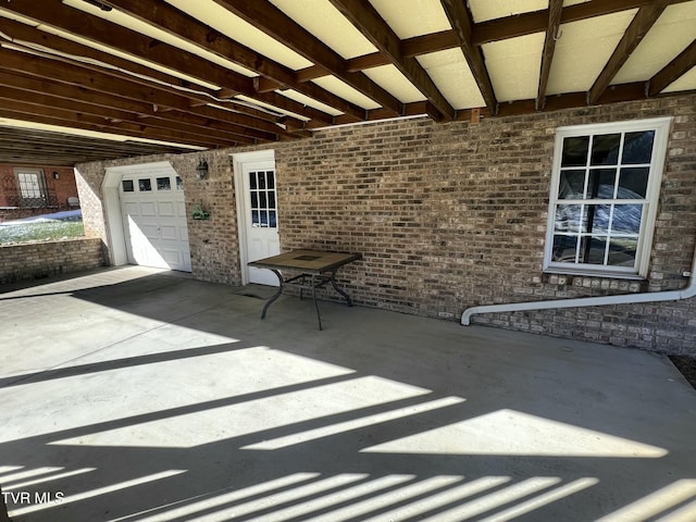 view of patio / terrace with a garage and concrete driveway