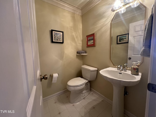 bathroom featuring ornamental molding, baseboards, and toilet