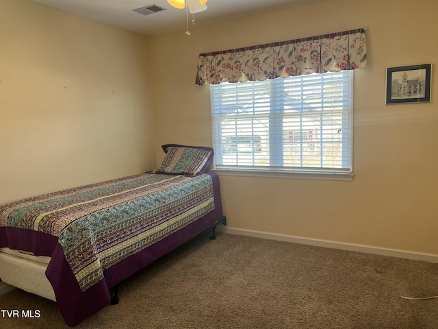 carpeted bedroom with visible vents and baseboards