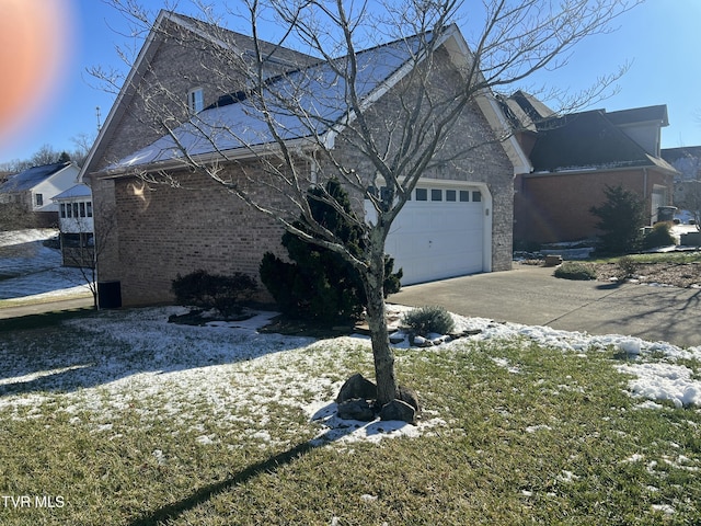 view of snow covered exterior featuring a garage