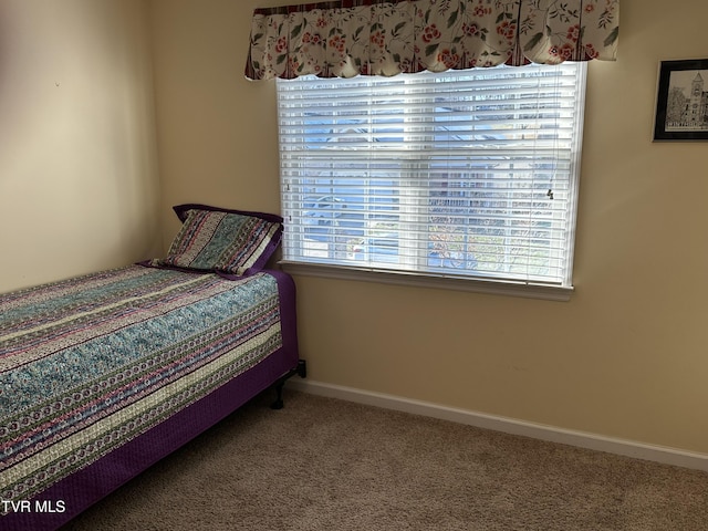 carpeted bedroom with baseboards