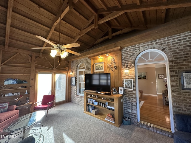 carpeted living room featuring lofted ceiling with beams, wooden ceiling, and brick wall