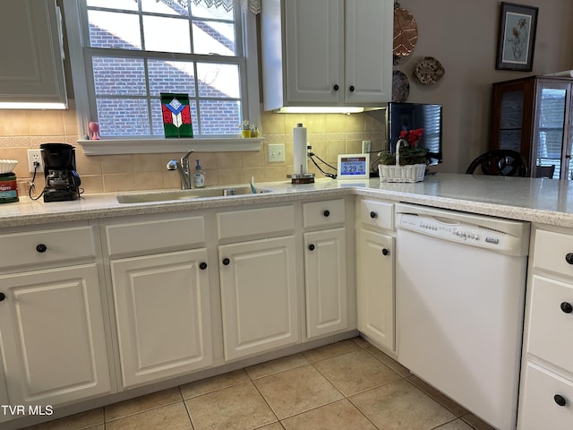 kitchen with a sink, white cabinetry, light countertops, decorative backsplash, and dishwasher