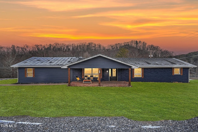 view of front of property featuring a patio area and a yard