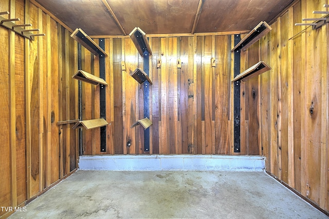 basement with wooden ceiling and wood walls