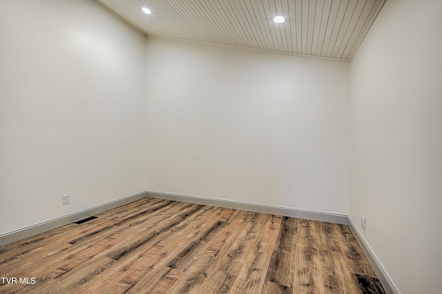 unfurnished room with wood-type flooring