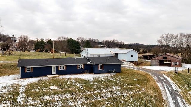 exterior space featuring cooling unit, a yard, and an outdoor structure