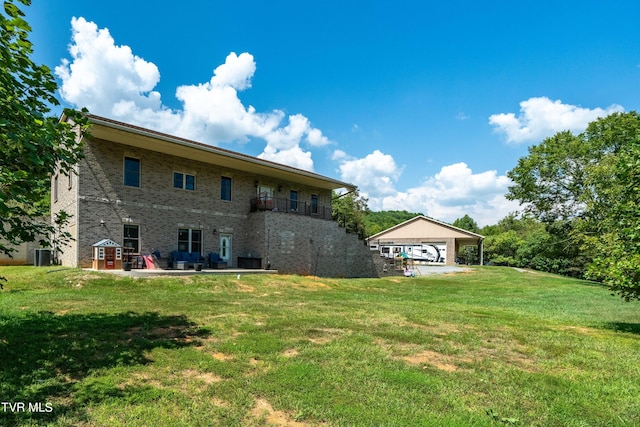 back of property with a yard and a garage