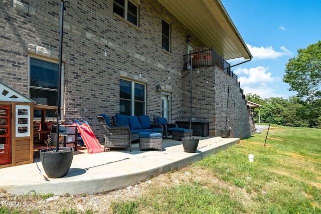 exterior space featuring an outdoor hangout area, a patio, and a lawn