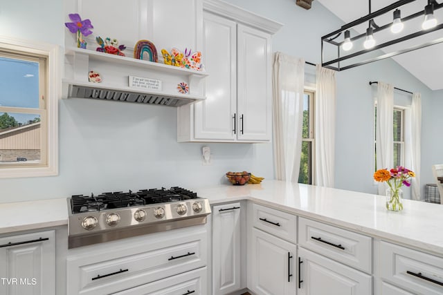 kitchen with white cabinets, pendant lighting, vaulted ceiling, and stainless steel gas cooktop