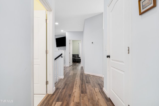 hallway with dark hardwood / wood-style flooring