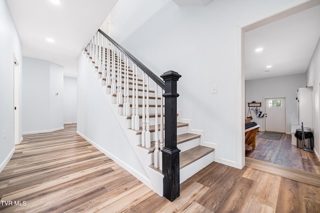 staircase featuring wood-type flooring