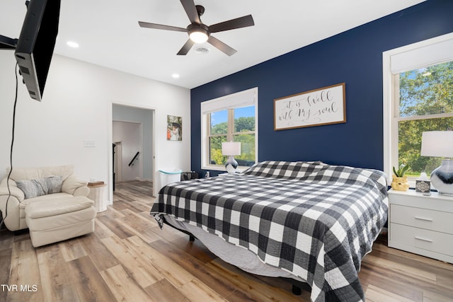 bedroom featuring ceiling fan and light hardwood / wood-style flooring