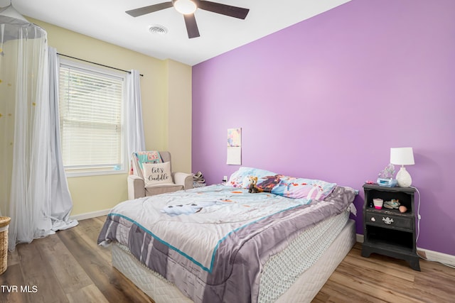 bedroom with hardwood / wood-style floors and ceiling fan