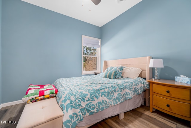 bedroom with ceiling fan and hardwood / wood-style flooring