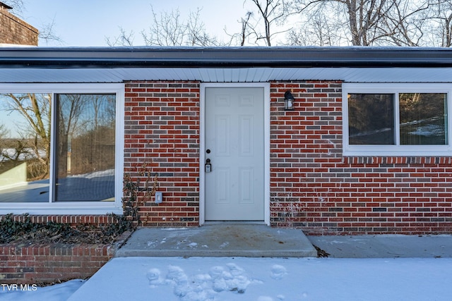 view of snow covered property entrance