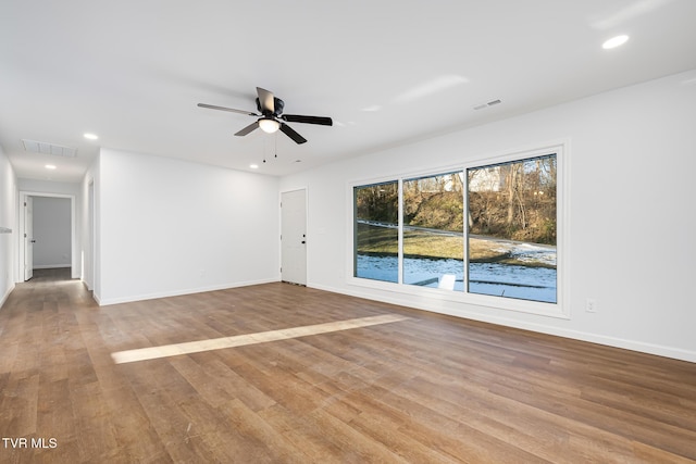 empty room with ceiling fan and light wood-type flooring