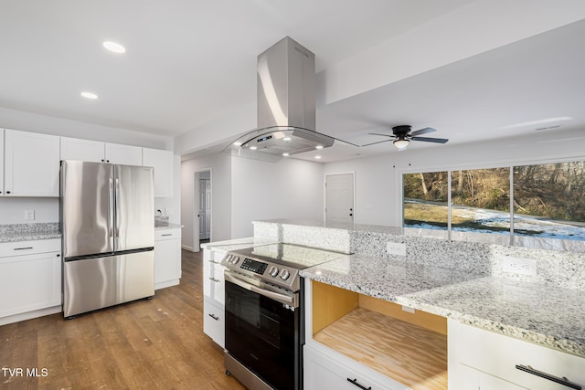 kitchen featuring island exhaust hood, white cabinetry, stainless steel appliances, and ceiling fan