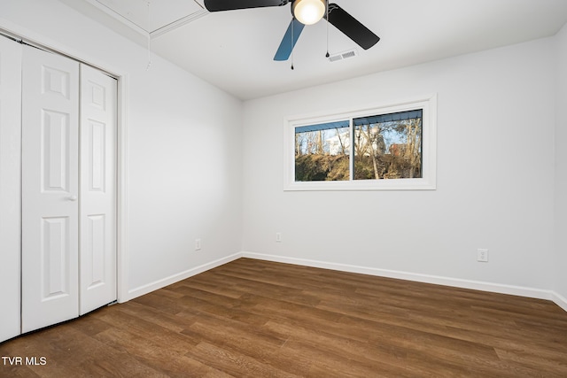 unfurnished bedroom featuring ceiling fan, a closet, and dark hardwood / wood-style floors