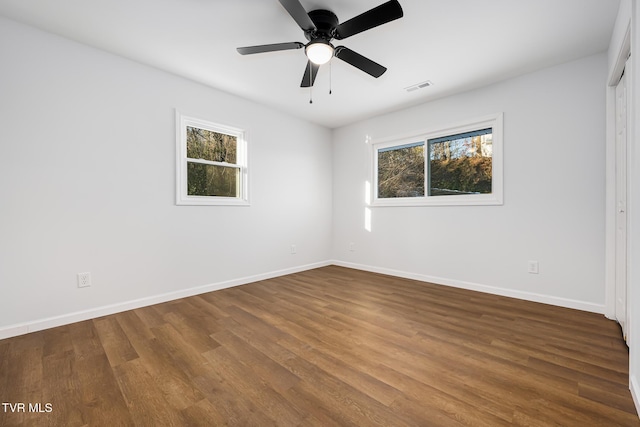 unfurnished room featuring ceiling fan and dark hardwood / wood-style flooring